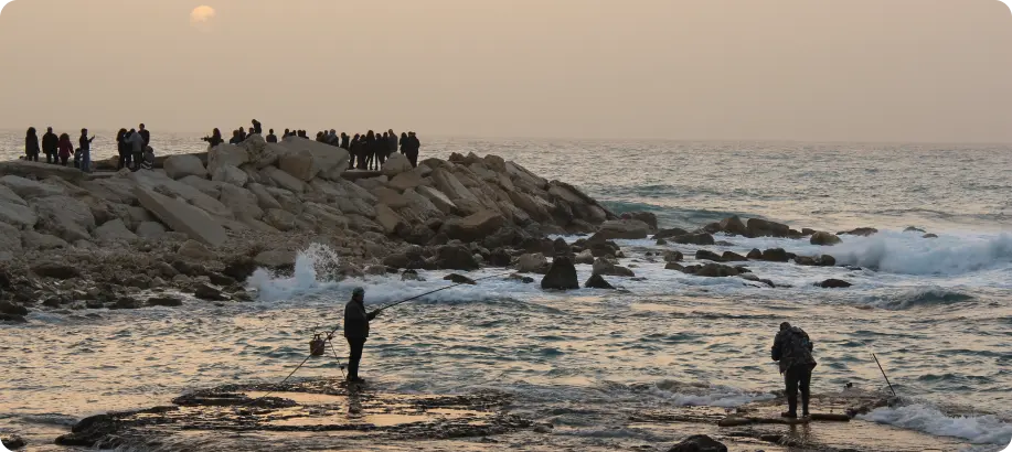 People next to the sea