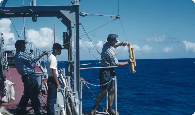 A person on the boat holding something in the hand