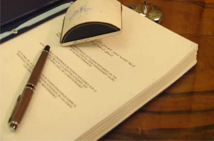 A book and a pen on the desk with UN